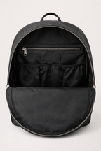 Black backpack with open front compartment on a light gray background