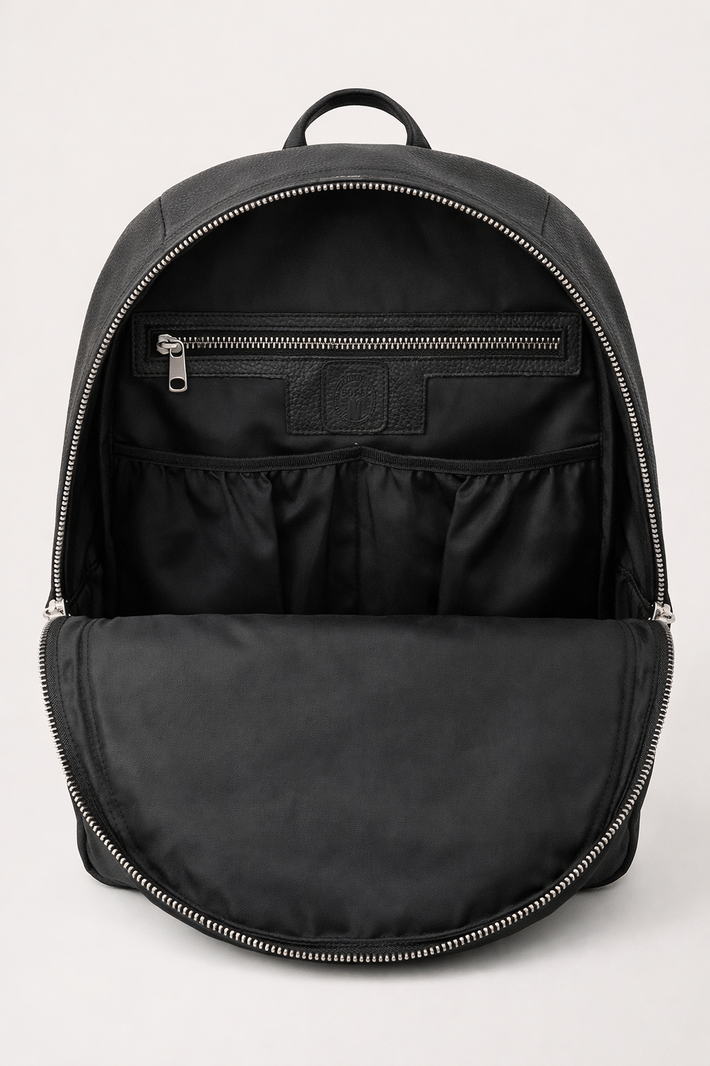 Black backpack with open front compartment on a light gray background