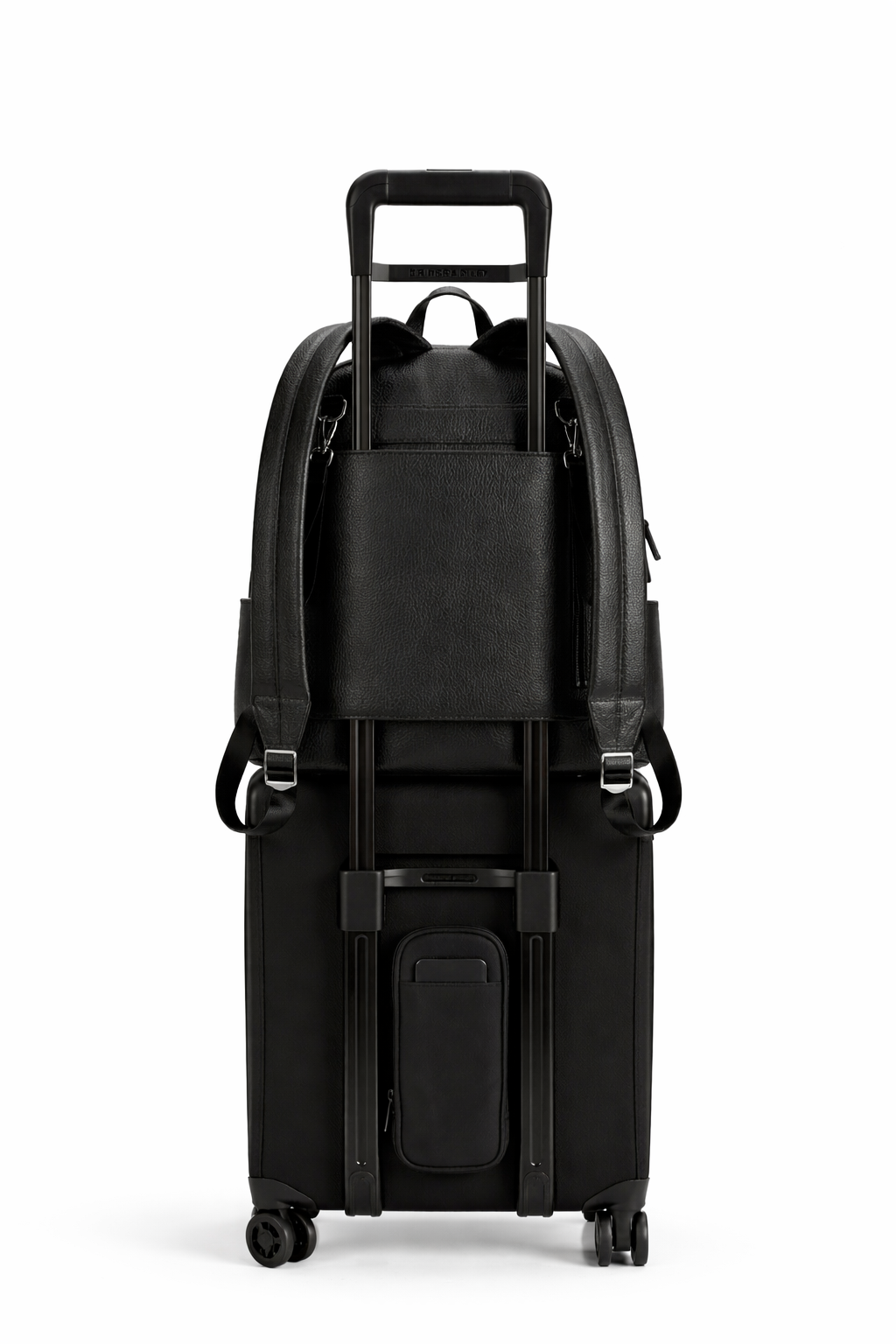 Black suitcase with a backpack style nappy bag on top on a white background