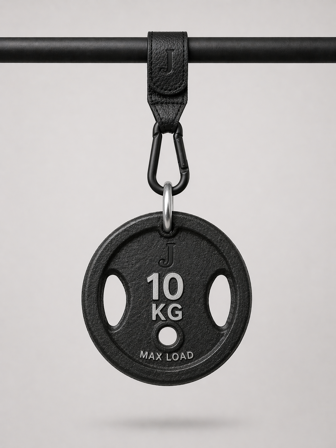 Black weight plate with '10 KG' marking on a gray background being held up by a Josalis The Mira Buggy clip 