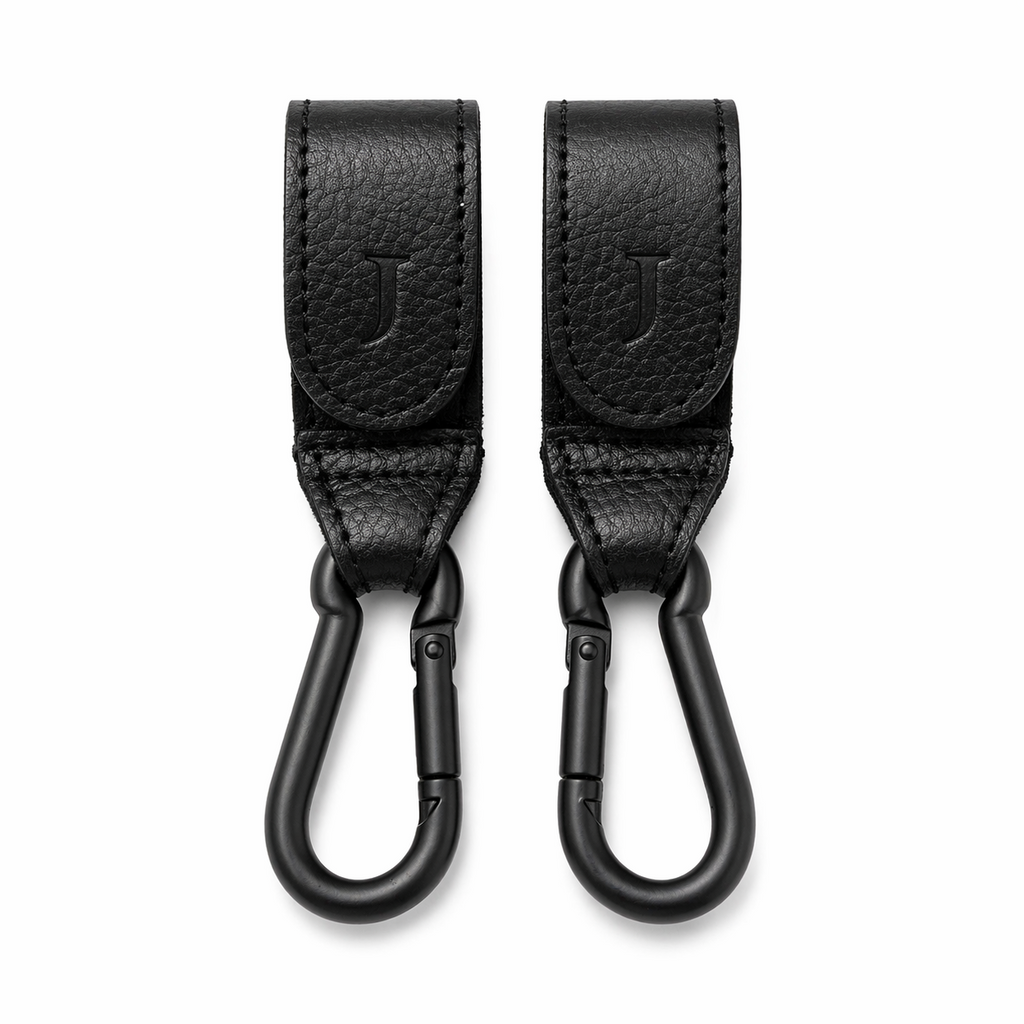 Two black leather Mira Buggy clips with matte black carabiners 